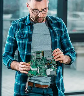 Engineer with circuit board - we assistance with Callaghan Innovation MBIE grant applications